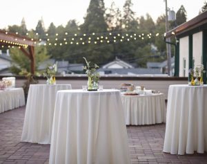 Wedding party with cocktail tables and linens